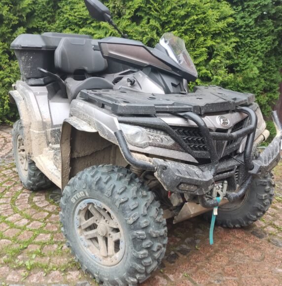 CFMoto CForce 1000 ATV with a rear cargo box, parked in a garden