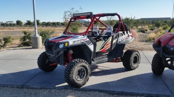 Polaris RZR XP 900 sport side by side on a concrete pad