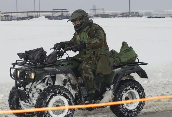 Honda FourTrax Rancher ATV ridden by an owner in snow